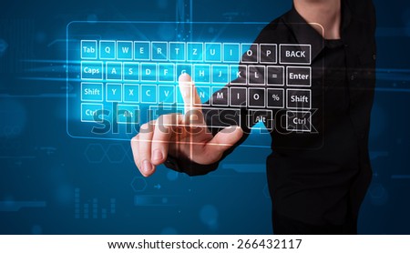 Young businessman pressing virtual type of keyboard