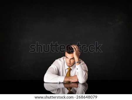 Depressed businessman sitting at a desk