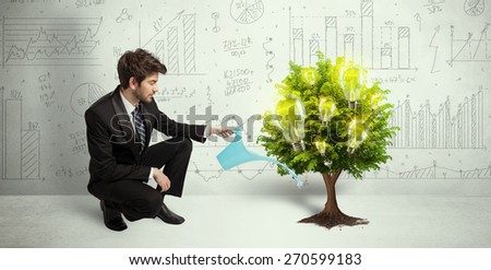 Business man pouring water on lightbulb growing tree concept