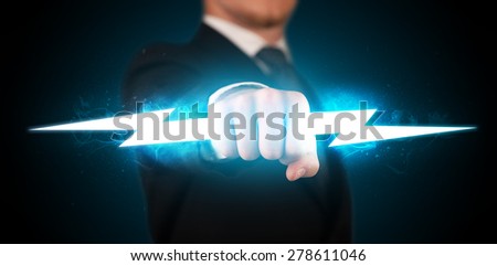 Business man holding glowing lightning bolt in his hands concept