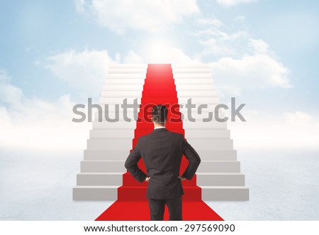 Businessman looking at stairs to heaven