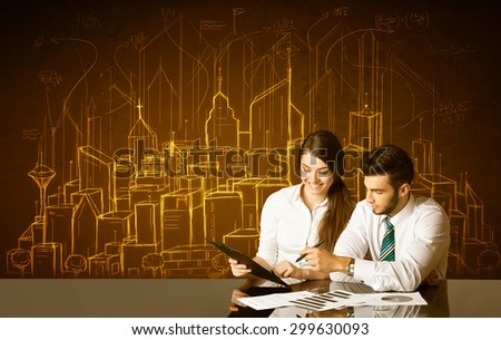 Business couple sitting at the black table with hand drawn buildings and numbers on the background