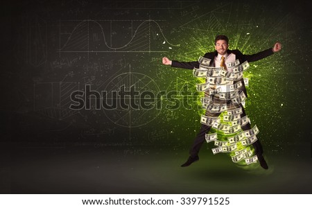 Cheerful businesman jumping with dollar banknotes around him on background