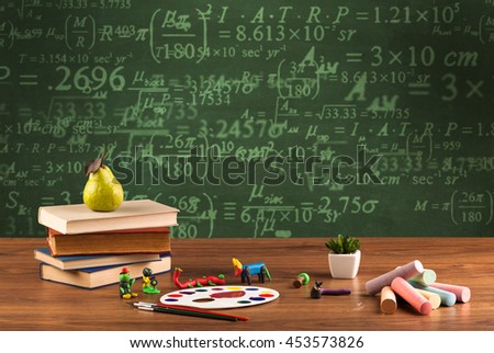 A stuffed school desk with green blackboard in the background full of numbers, calculation