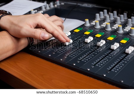 mixing desk and human hand diminishing perspective