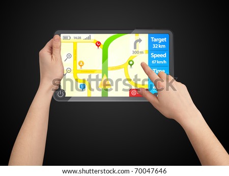 a male hand holding a touchpad gps, one finger touches the screen