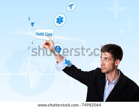 Young doctor pressing Health Care button, futuristic technology