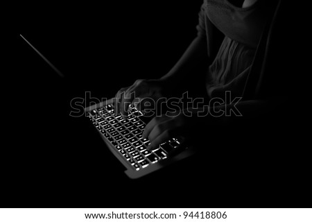 black computer keyboard with typing hands