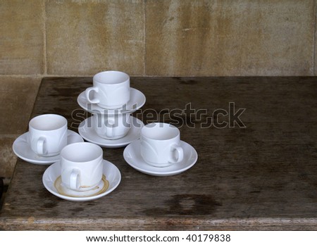 A group of empty coffee cups for espresso and saucers on the kitchen table