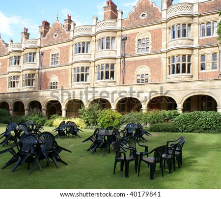 Plastic tables and chairs on the lawn in the courtyard of Sidney Sussex College, Cambridge University