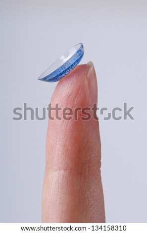 Color contact lens on a finger
