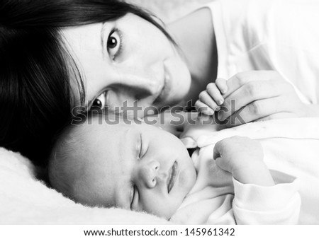 Newborn baby with happy mother, black and white