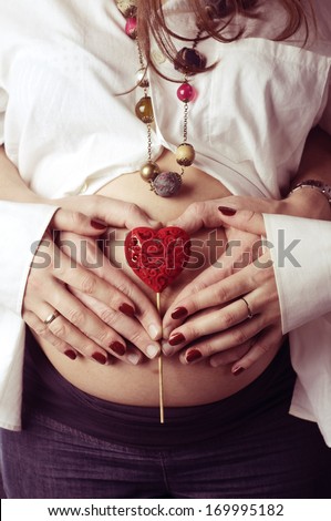 Heart on pregnant woman belly