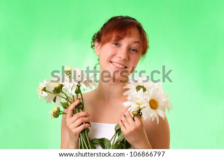 Funny young girl with chamomile flowers