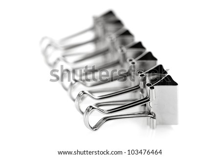 Row of steel metal clips on white background
