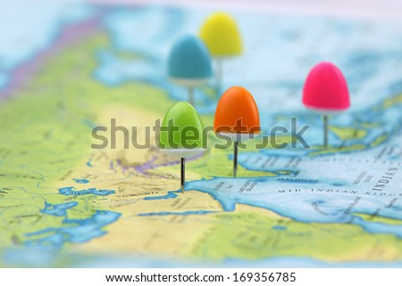 Thumb tacks on Asia map