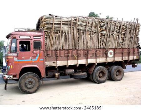 Old truck carrying full load of woods