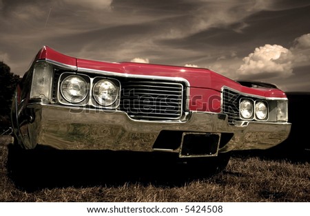 Red American muscle car with sepia color tone
