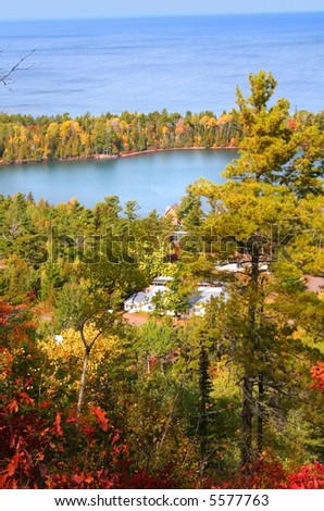 Colorful trees by blue water Superior lake at copper harbor