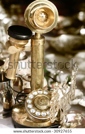 Antique golden phone in the middle of ornaments