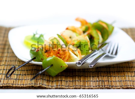 Grilled shrimp and vegetable skewers on plate