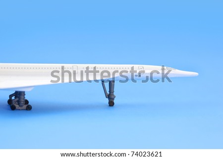 Toy airplane on plain blue background