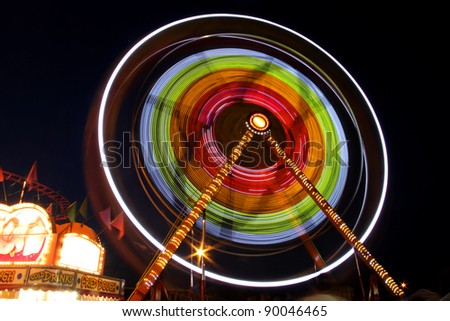 Rotating carnival giant wheel in night time