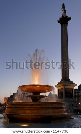 Trafalgar square at night with Nelson's Column and illuminated fountain