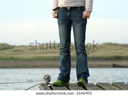 Teenager waits and looks for her fathers boat to come back form sailing his boat