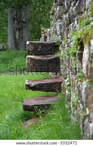 Well worn stone step which help you get over the wall