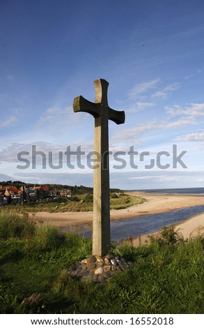 Cross on the hill in front of the beautiful village of Alnmouth