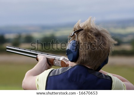 Young boy clay pigeon shooting