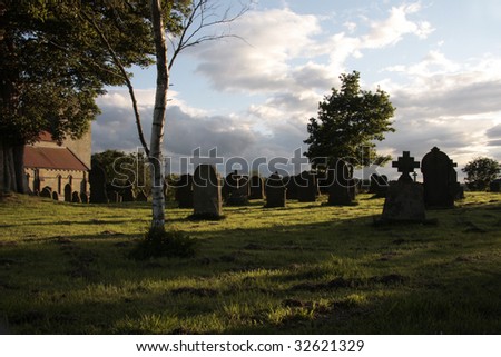 Evening sun on the church yard cast long shadows from the gravestones