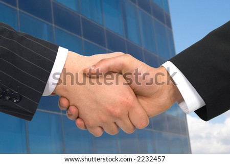 business handshake on modern office building, both files are from photographers portfolio