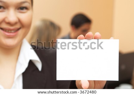 young businesswoman holding her blank business card