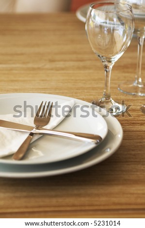 restaurant service table with empty plates and glasses