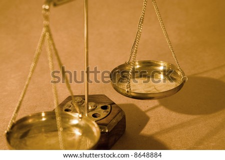 Scales of justice close up on paper background, shallow dof