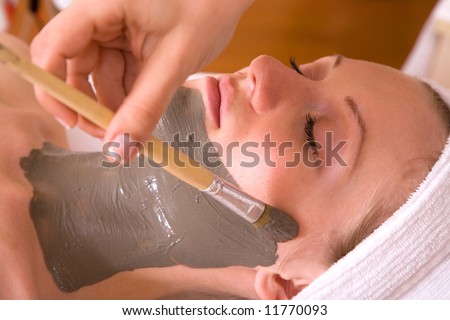 woman having a face care session at the spa center
