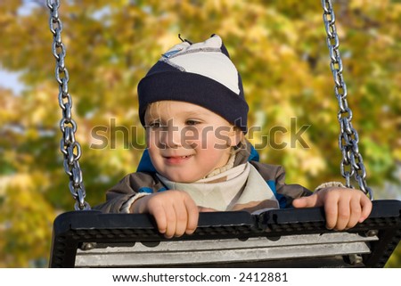 Little blond caucasian boy (2,5 years old) playing outside.