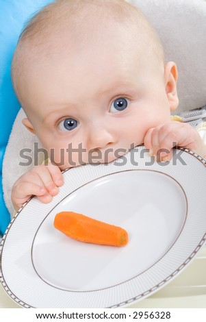 Six month old baby girl with her first ever... well... carrot.
