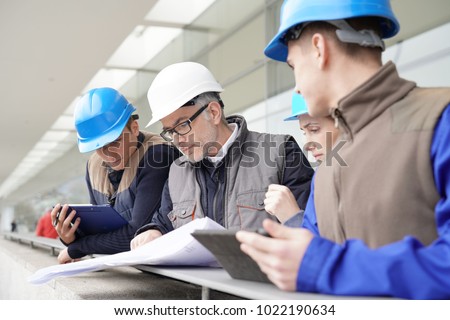 Construction manager giving instructions to training students