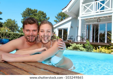 Young couple in private swimming pool