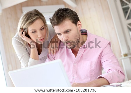 Couple at home using laptop computer