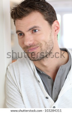 Portrait of handsome man leaning on wall