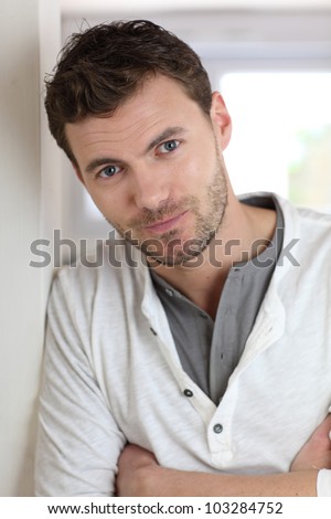 Portrait of handsome man leaning on wall