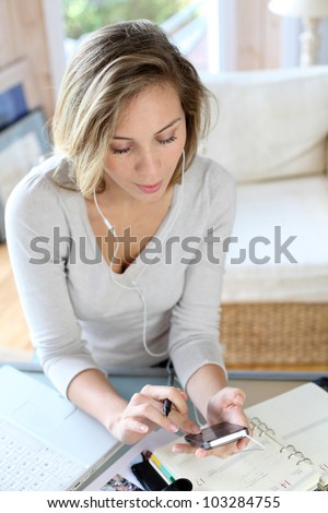 Woman typing message on smartphone