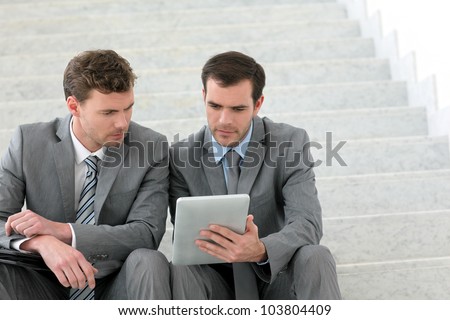 Business meeting in stairs with electronic tablet