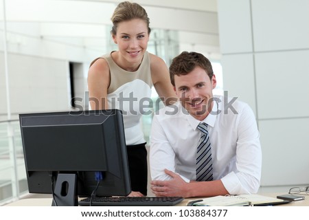 Business people meeting in office in front of desktop