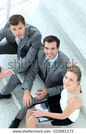 Upper view of business team sitting in stairs