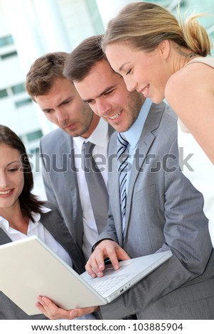 Business team consulting program on laptop